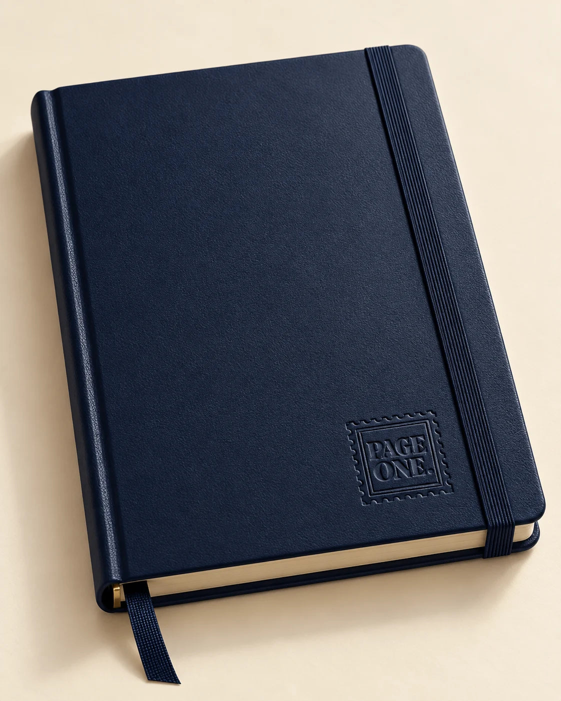 Midnight navy diary with a debossed Page One stamp near the lower cover